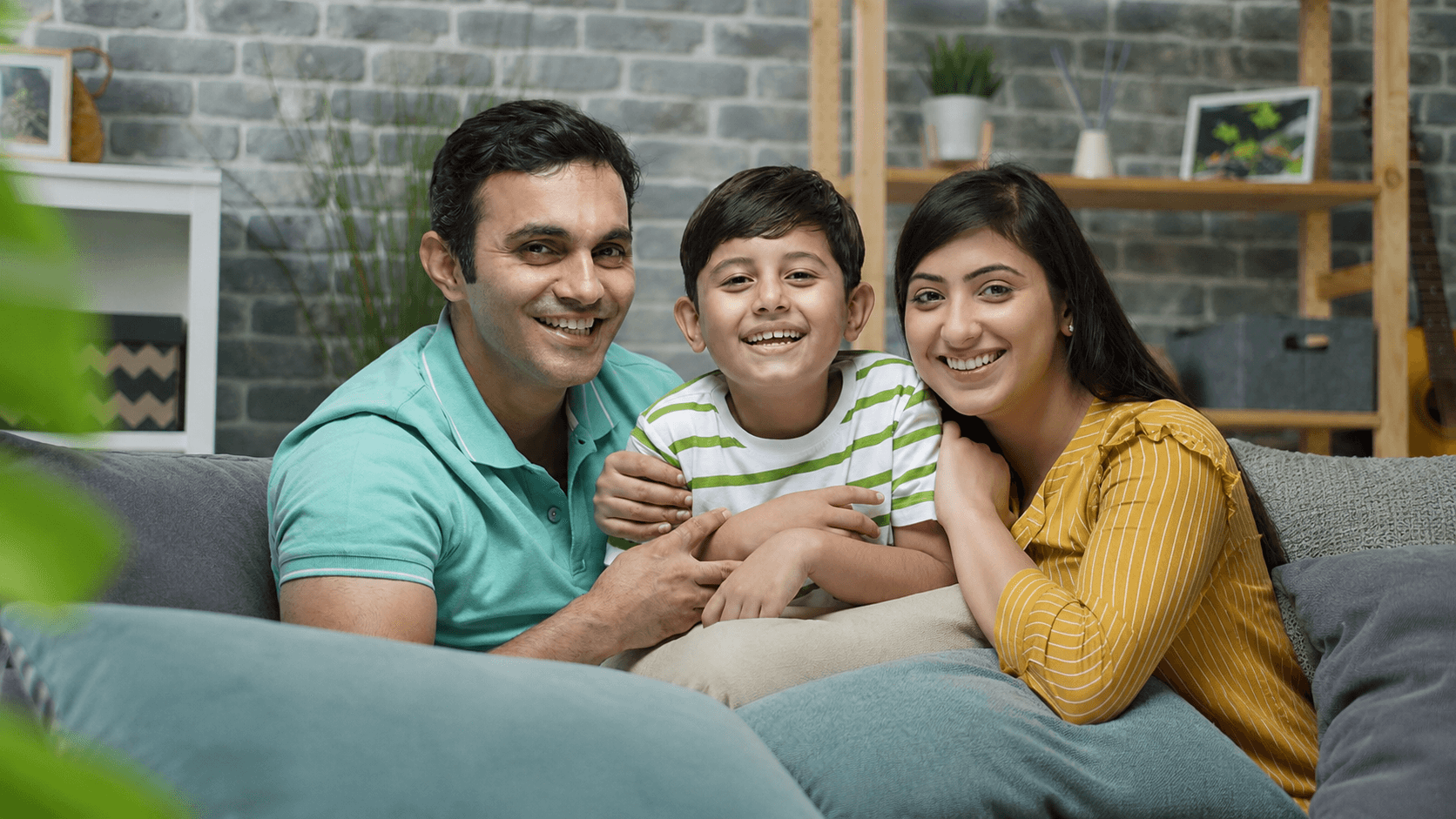 A Bangladeshi family smiling together at home